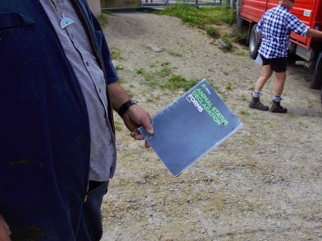 A man holding up an ASD book