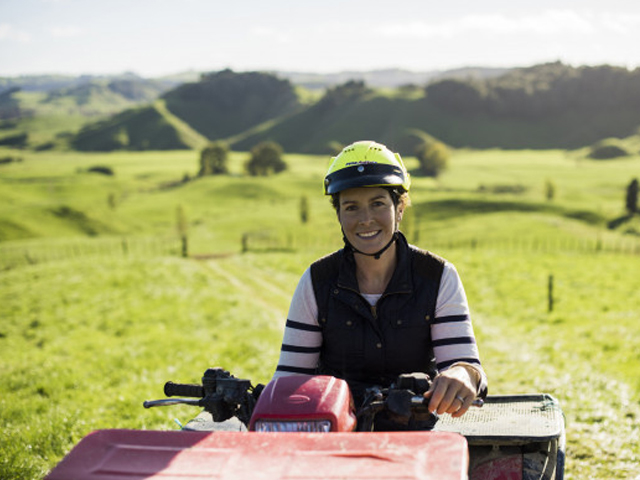 A woman on a quad bike, smiling for the camera