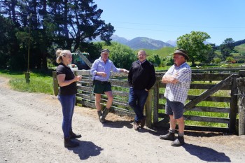 OSPRI staff and South Island farmers in conversation on a sunny day