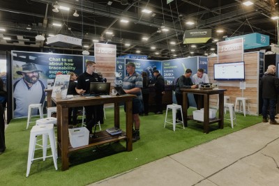 wide camera shot of the OSPRI stand at National Fieldays. OSPRI staff talking to event-goers