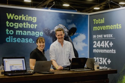 two OSPRI staff members at an event, smiling at the camera